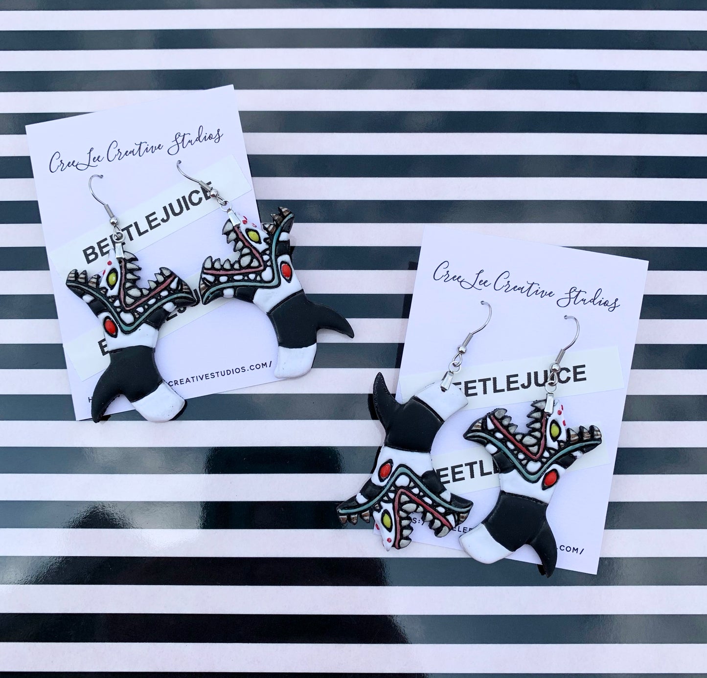 Sandworm from Beetlejuice handpainted on an earring card branded CreeLee Creative Studios.