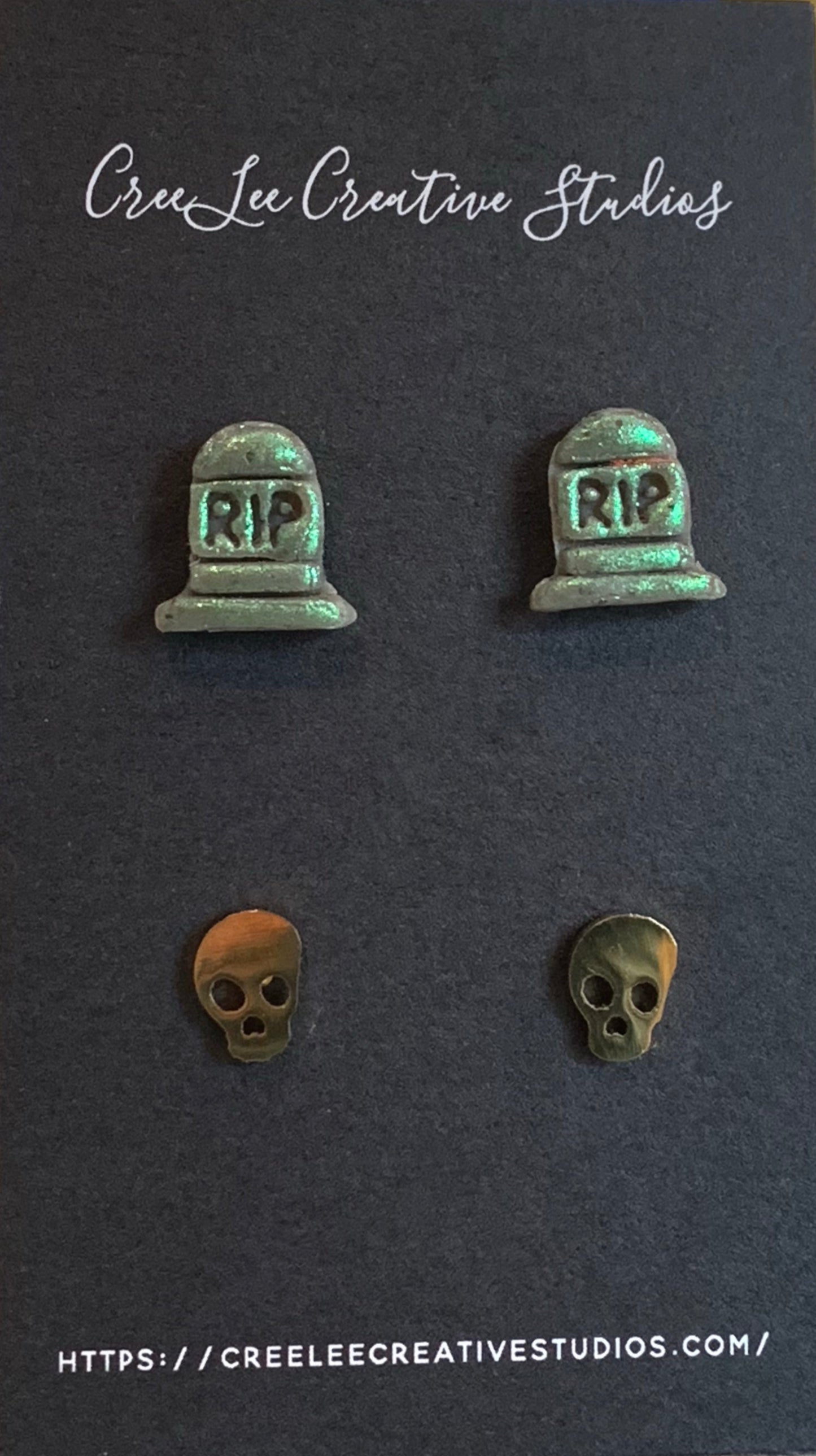 Set of earrings with 'RIP' tombstone and skull designs on a dark background with 'Cree Lee Creative Studios' branding.