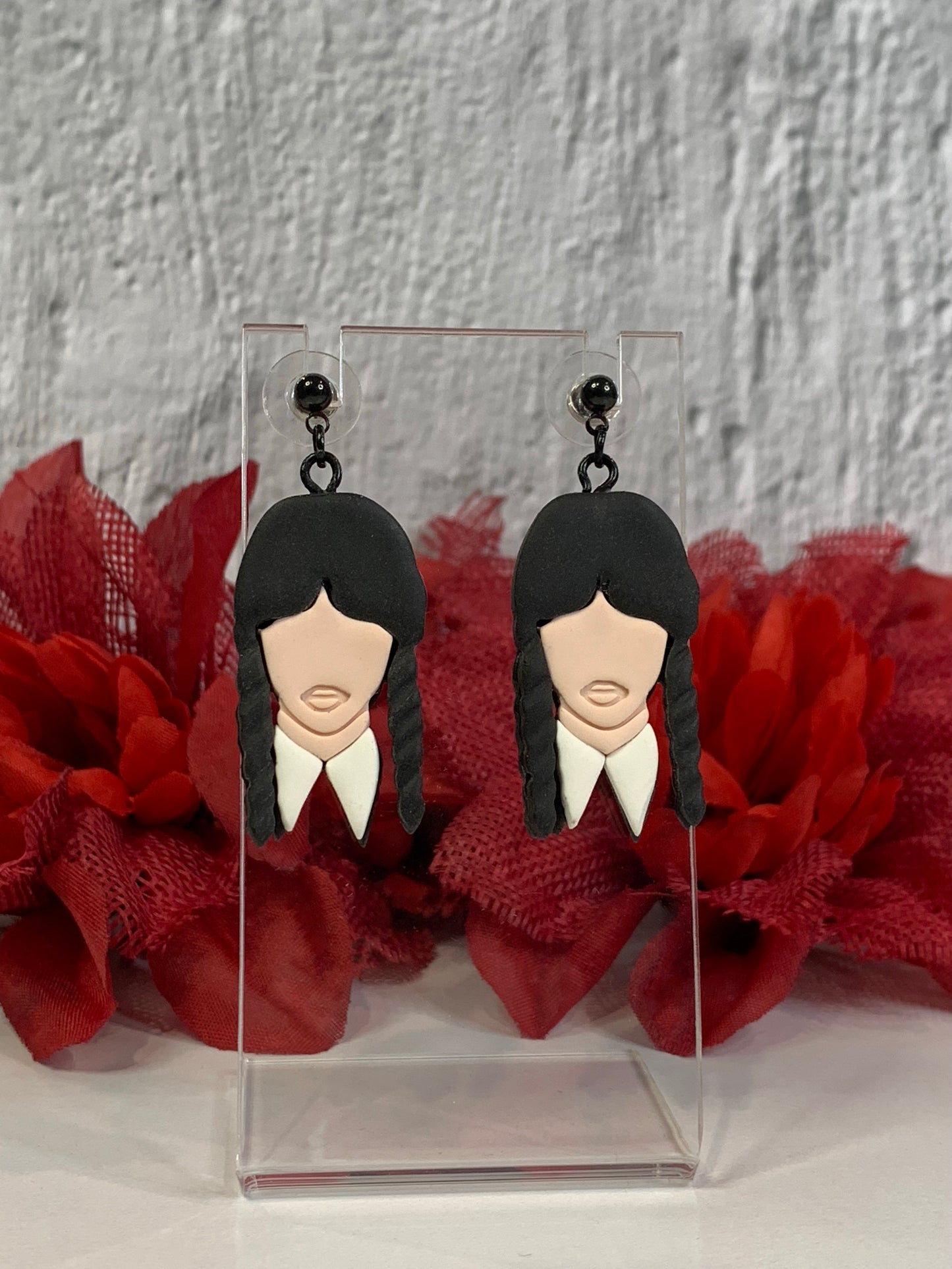 Handmade Classic Wednesday Addams earrings — lightweight polymer clay dangles that capture Wednesday’s iconic black braids and crisp white collar. Perfect for gothic jewelry lovers, Addams Family fans, or Nevermore Academy cosplay, these small-batch earrings bring spooky-chic style to everyday wear or Halloween costumes. Each pair is hand-sculpted, finished with durable black-plated stainless-steel findings, and designed to be comfortable for all-day wear.