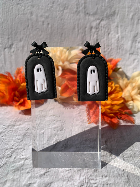 Handmade Black Ghost Arch Earrings — gothic statement polymer clay earrings featuring a stitched black arch, white ghost, and black bow findings. Perfect goth earrings, Halloween ghost earrings, and spooky cute gothic jewelry. Lightweight, durable, and wearable for Halloween, gothic fashion, or everyday eerie elegance.