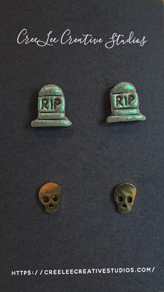Set of earrings with 'RIP' tombstone and skull designs on a dark background with 'Cree Lee Creative Studios' branding.