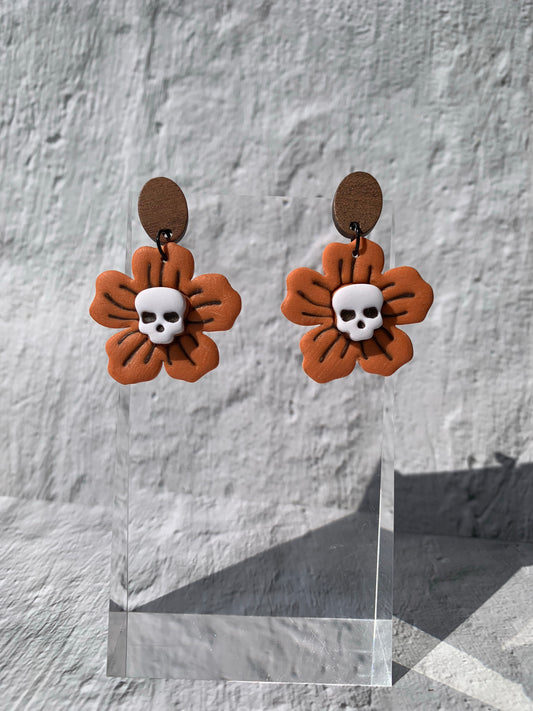 Orange flower earrings with skull center on an oval wooden finding