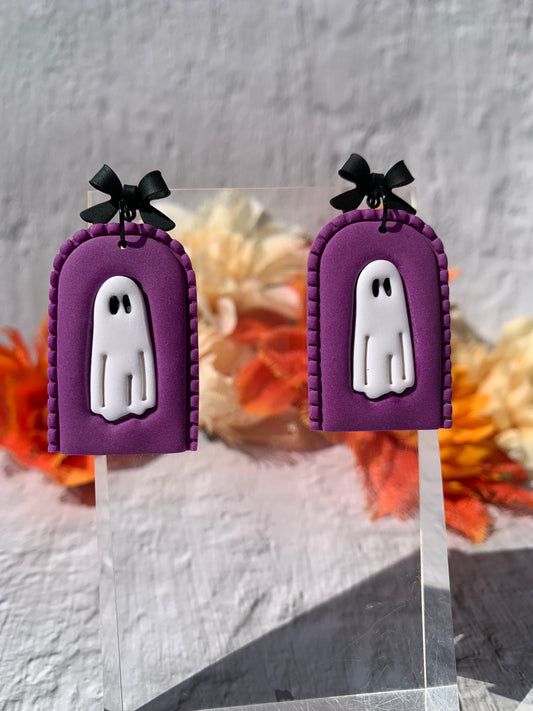 Handmade Deep Purple Ghost Arch Earrings — gothic-inspired polymer clay earrings featuring a white ghost in a stitched purple arch with black bow findings. 